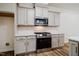 Modern kitchen with stainless steel oven, range, and microwave, complemented by light gray cabinets and quartz countertops at 361 Anterbury Dr # B, Apex, NC 27502