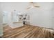 Open-concept kitchen and living area featuring wood floors and modern lighting at 361 Anterbury Dr # B, Apex, NC 27502