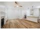 Open-concept living area flows into the kitchen, featuring wood floors and a fireplace at 361 Anterbury Dr # B, Apex, NC 27502