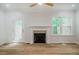 Bright living room featuring a cozy fireplace, ceiling fan, and wood floors at 361 Anterbury Dr # B, Apex, NC 27502