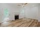 Bright living room featuring a cozy fireplace, ceiling fan, and wood floors at 361 Anterbury Dr # B, Apex, NC 27502