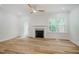 Bright living room featuring a cozy fireplace, ceiling fan, and wood floors at 361 Anterbury Dr # B, Apex, NC 27502