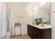 Bathroom featuring a wooden vanity, large mirror, and shower with a patterned curtain at 3904 Freemark Ln, Fuquay Varina, NC 27526