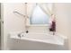Bathroom showcases a bathtub and window with decorative curtains for privacy at 3904 Freemark Ln, Fuquay Varina, NC 27526