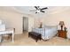 Bedroom featuring a ceiling fan, a metal bed frame, and a comfy bench at 3904 Freemark Ln, Fuquay Varina, NC 27526