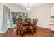 Elegant dining room with wooden table, ornate chairs, and stylish window treatments at 3904 Freemark Ln, Fuquay Varina, NC 27526
