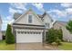 Attractive home exterior with a two-car garage and tidy landscaping at 3904 Freemark Ln, Fuquay Varina, NC 27526