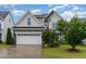 Charming two-story home featuring stone accents, a two-car garage, and a beautifully landscaped front yard at 3904 Freemark Ln, Fuquay Varina, NC 27526