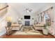 Cozy living room with built-in shelving, a fireplace, comfortable seating, and lots of natural light at 3904 Freemark Ln, Fuquay Varina, NC 27526