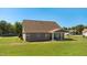 View of the backyard featuring a well-maintained lawn with a covered patio area perfect for outdoor entertaining at 3909 Mendenhall Dr, Zebulon, NC 27597