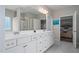 Well-lit bathroom with a large vanity, double sinks, and an open view into the Primary bedroom at 3909 Mendenhall Dr, Zebulon, NC 27597