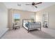 Comfortable bedroom with large window, bed, ceiling fan, and access to the bathroom at 3909 Mendenhall Dr, Zebulon, NC 27597