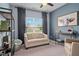 Bright room featuring a seating area with sofa and shelving unit, with a large window offering views at 3909 Mendenhall Dr, Zebulon, NC 27597
