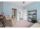 Relaxing bedroom with a comfortable armchair, open doorway, and modern shelves for storage at 3909 Mendenhall Dr, Zebulon, NC 27597