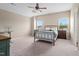 Cozy bedroom featuring a metal bed frame, neutral walls, and carpeted floor; windows offer natural light at 3909 Mendenhall Dr, Zebulon, NC 27597