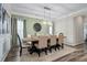 Stylish dining room with a modern chandelier, wainscoting, and a large dining table at 3909 Mendenhall Dr, Zebulon, NC 27597