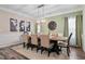 Elegant dining room with wainscoting, a modern chandelier, and a large dining table at 3909 Mendenhall Dr, Zebulon, NC 27597