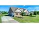 Beautiful home with lush lawn and well-manicured shrubs and landscaping makes for great curb appeal at 3909 Mendenhall Dr, Zebulon, NC 27597