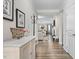 Inviting hallway with wood floors leads to a cozy living space and dining room, brightened by natural light at 3909 Mendenhall Dr, Zebulon, NC 27597