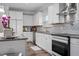 White cabinets and stainless steel appliances in the kitchen with tile backsplash at 3909 Mendenhall Dr, Zebulon, NC 27597