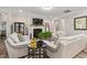 Stylish living room with a fireplace, modern decor, hardwood floors, and access to other living areas at 3909 Mendenhall Dr, Zebulon, NC 27597