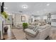 Open-concept living area featuring hardwood floors, modern furniture, and seamless flow to the kitchen at 3909 Mendenhall Dr, Zebulon, NC 27597