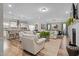 Bright living room with hardwood floors, modern furniture, an open layout, and a view into the kitchen at 3909 Mendenhall Dr, Zebulon, NC 27597