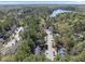 Community aerial view shows the neighborhood streets, mature trees, lake and surrounding area at 3940 Lake Ferry Dr, Raleigh, NC 27606