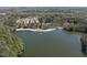 Beautiful aerial view showcases a serene lake with nearby apartments surrounded by lush trees at 3940 Lake Ferry Dr, Raleigh, NC 27606