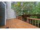 Wooden back deck with railings overlooking lush greenery, offering a private outdoor space at 3940 Lake Ferry Dr, Raleigh, NC 27606