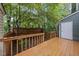 Wooden back deck with railings overlooking lush greenery, offering a private outdoor space at 3940 Lake Ferry Dr, Raleigh, NC 27606