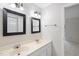 Bathroom features a double vanity with white cabinets, granite counters and framed mirrors at 3940 Lake Ferry Dr, Raleigh, NC 27606