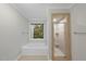 Bathroom featuring a bathtub, shower and a window with a view to the outdoors at 3940 Lake Ferry Dr, Raleigh, NC 27606
