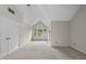 Bedroom features a vaulted ceiling, neutral carpeting, and a bright arched window at 3940 Lake Ferry Dr, Raleigh, NC 27606