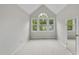 Bedroom features a vaulted ceiling, neutral carpeting, and a bright arched window at 3940 Lake Ferry Dr, Raleigh, NC 27606