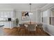 Cozy dining area features wood floors, stylish chandelier and view to the kitchen at 3940 Lake Ferry Dr, Raleigh, NC 27606