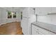 White kitchen features matching refrigerator, cabinets, and a view of an adjacent breakfast nook at 3940 Lake Ferry Dr, Raleigh, NC 27606