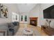 Bright living room features a fireplace, hardwood floors and vaulted ceiling at 3940 Lake Ferry Dr, Raleigh, NC 27606