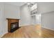 A spacious living room with hardwood flooring, a fireplace, and a vaulted ceiling at 3940 Lake Ferry Dr, Raleigh, NC 27606