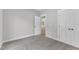 Neutral-toned bedroom featuring two closets and view into another room at 401 N Raiford St, Selma, NC 27576