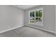 Bright bedroom features neutral walls, carpeted floors, and a large window at 401 N Raiford St, Selma, NC 27576
