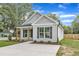 Charming home featuring black shutters, light gray siding, and a concrete driveway at 401 N Raiford St, Selma, NC 27576