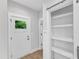 Hallway area featuring a white front door with a window and a storage area with a sliding door at 401 N Raiford St, Selma, NC 27576
