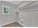 Laundry room with a window, gray walls, a wood rack, and hookups for a washer and dryer at 401 N Raiford St, Selma, NC 27576
