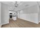 Open living room with luxury vinyl plank flooring and a modern white kitchen at 401 N Raiford St, Selma, NC 27576