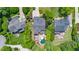 Aerial view of the property showcasing the house, mature landscaping, and backyard pool oasis at 404 Brightling Way, Holly Springs, NC 27540
