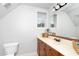 Attic bathroom featuring a light-colored sink and plenty of natural light at 404 Brightling Way, Holly Springs, NC 27540