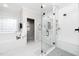 Bright bathroom with a glass shower, tub, and a sleek vanity at 404 Brightling Way, Holly Springs, NC 27540