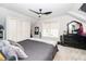 Attic bedroom featuring a dark bed, fan and lots of storage at 404 Brightling Way, Holly Springs, NC 27540