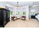 Relaxing sitting area in the bedroom with accent chairs, natural light and tray ceilings at 404 Brightling Way, Holly Springs, NC 27540